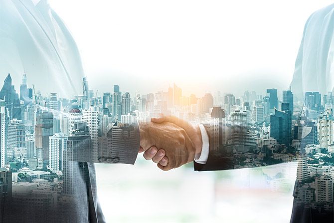 Two men in suits shaking hands